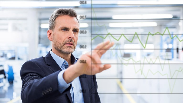 Worker viewing graph on manufacturing floor
