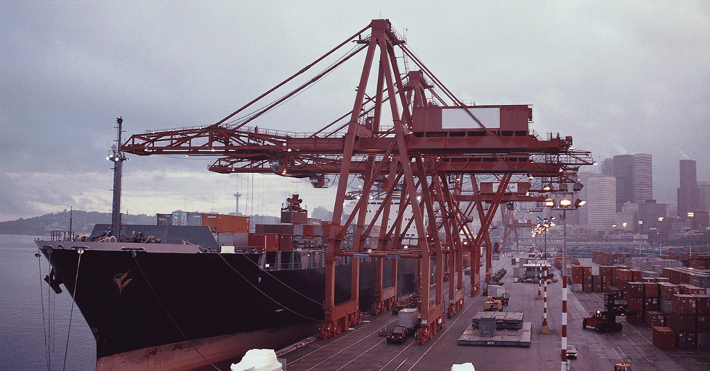 Harbor cranes loading and unloading cargo from container ships.