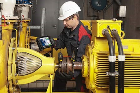 maintenance technician corrects a shaft alignment problem