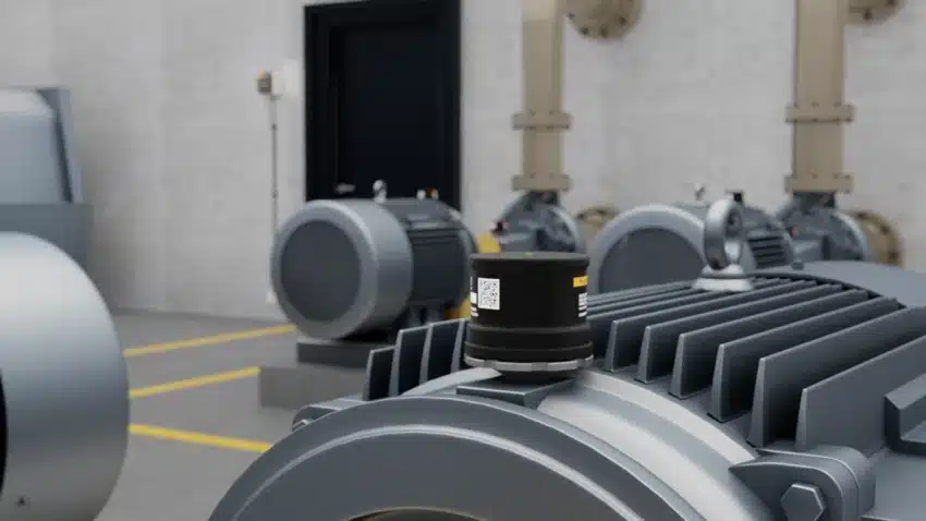 Fluke 3563 analysis vibration sensor system mounted on a machine in a manufacturing facility.